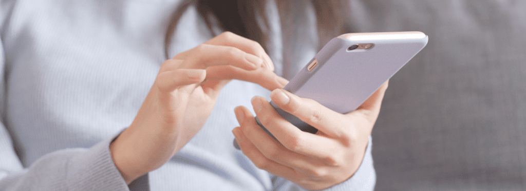 A close up of a woman's hands holding a smartphone | Midland Marketing