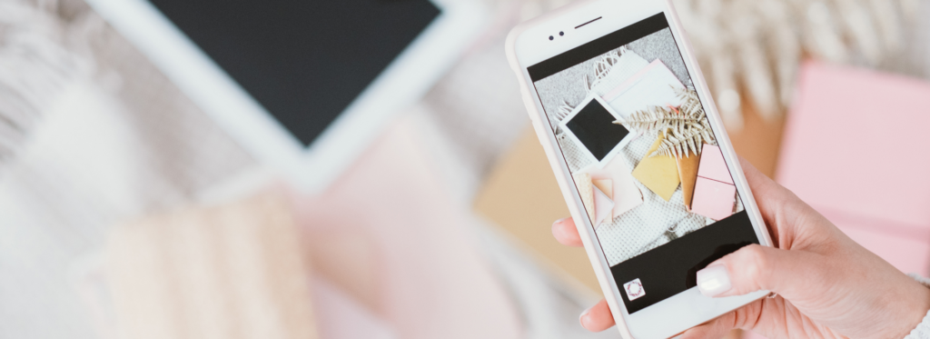 A close up photo of a woman taking a flat-lay photo on a smartphone - The Pros and Cons of Short Form Content