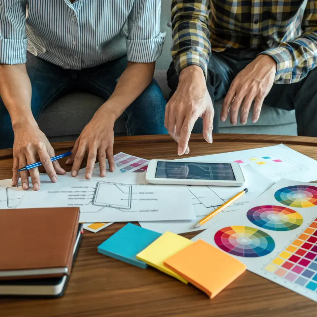A pair of web designers discussing potential website colour palettes as they design