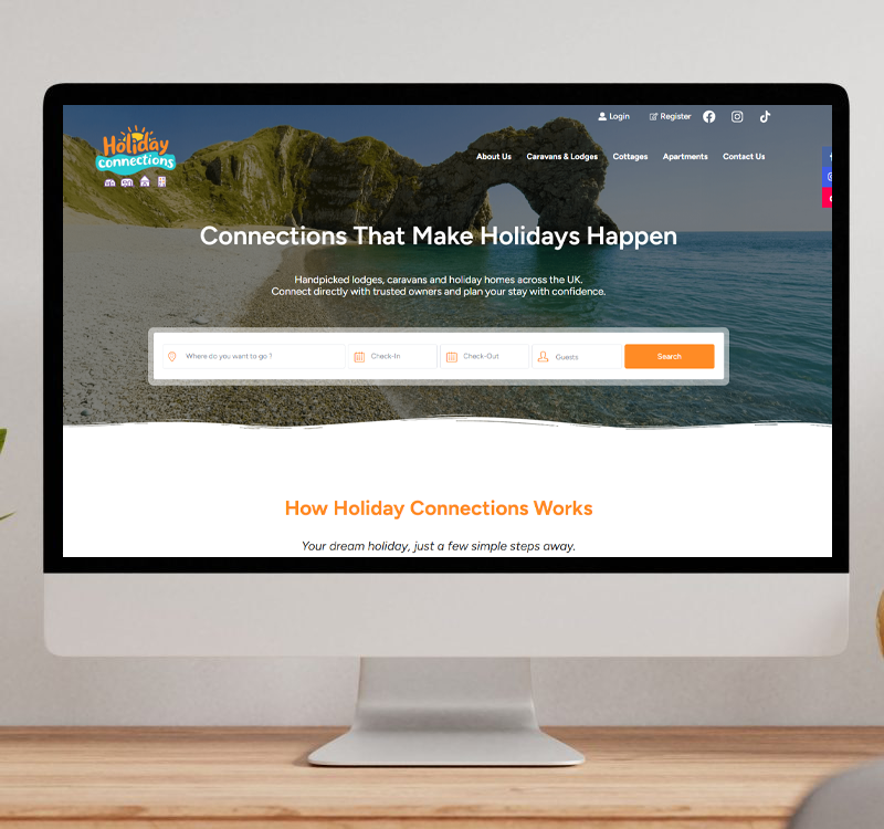 A desktop monitor displaying the Holiday Connections website homepage, featuring a scenic coastal background and a search bar for finding holiday lodges and caravans in the UK.
