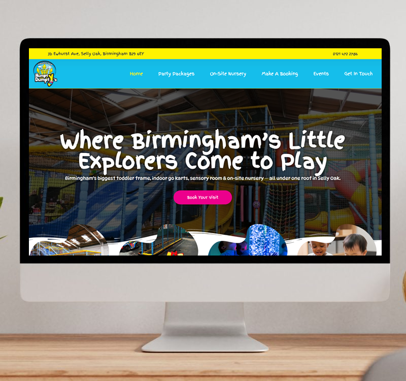 A desktop monitor displaying the Humpty Dumpty's website, featuring a large indoor play area background and links for party packages and nursery bookings.