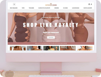 A desktop computer displaying the homepage of "Empress of London," a fashion e-commerce website featuring neutral-toned dresses and a "Shop Like Royalty" banner.