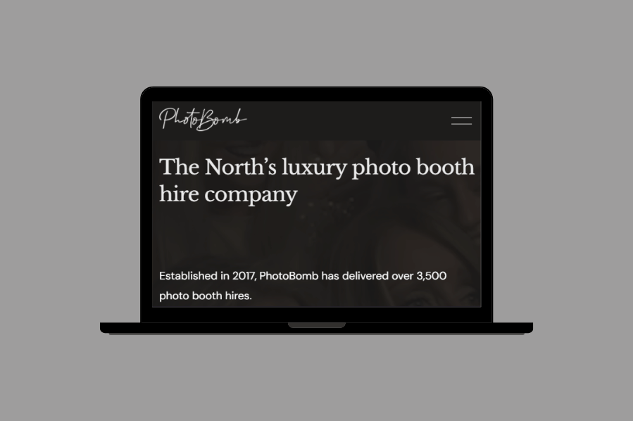 Laptop displaying PhotoBomb’s website with the headline “The North’s luxury photo booth hire company.”