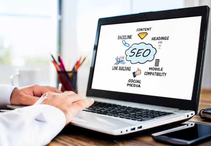 Laptop screen showing an SEO diagram with keywords like content, backlinks, and social media.