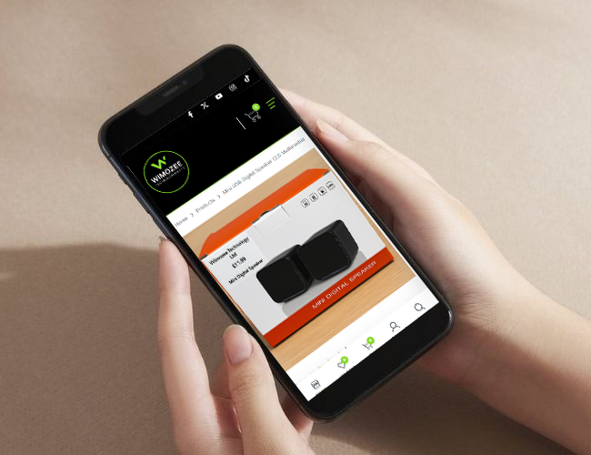 Hands holding a smartphone displaying a modern e-commerce website selling digital alarm clocks.