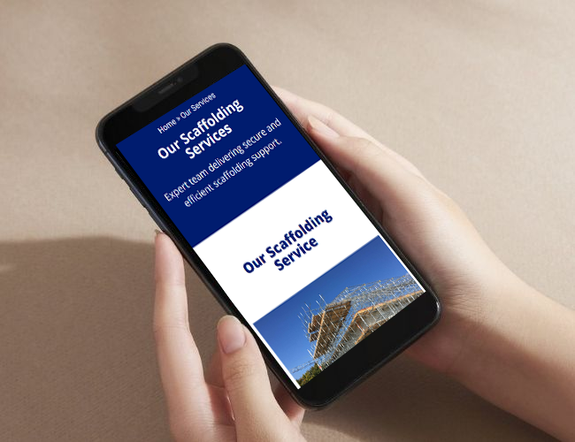 Smartphone displaying a scaffolding services website held in a person’s hands.