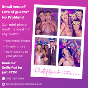 Guests posing and smiling in a mini photo booth at an event, enjoying fun props and taking unlimited photos together.