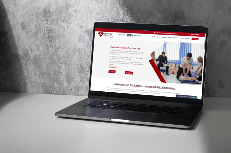 Desktop computer displaying the First Aid Training Services website for care and community marketing in the UK.