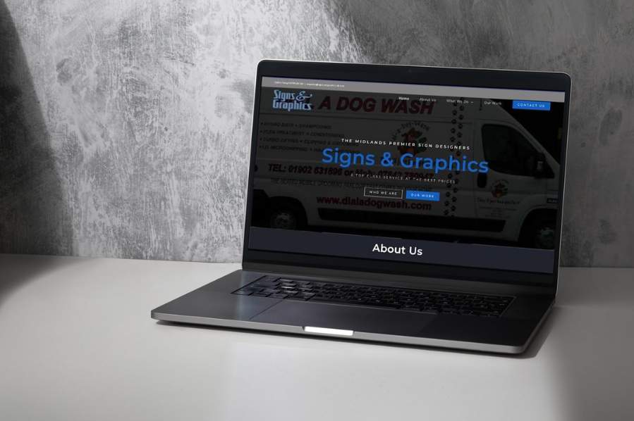 Desktop computer displaying the Signs & Graphics website, representing construction company marketing and industry-focused website design solutions for signage and graphics businesses.
