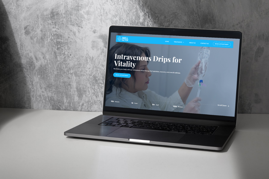 Desktop computer displaying the Well Factor wellness website, representing healthcare industry-focused marketing and IV therapy clinic website design solutions.
